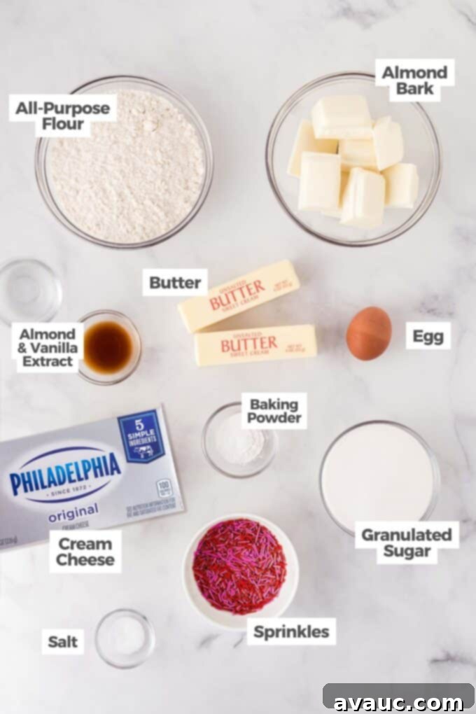Valentines Day Sugar Cookie Truffles 5 A flat lay of all the essential ingredients laid out for making sugar cookie Valentine truffles, including sugar cookies, cream cheese, white almond bark, and colorful sprinkles.