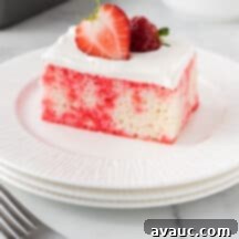 Strawberry Burst Poke Cake 11 Strawberry Jello Poke Cake with a perfect slice taken out