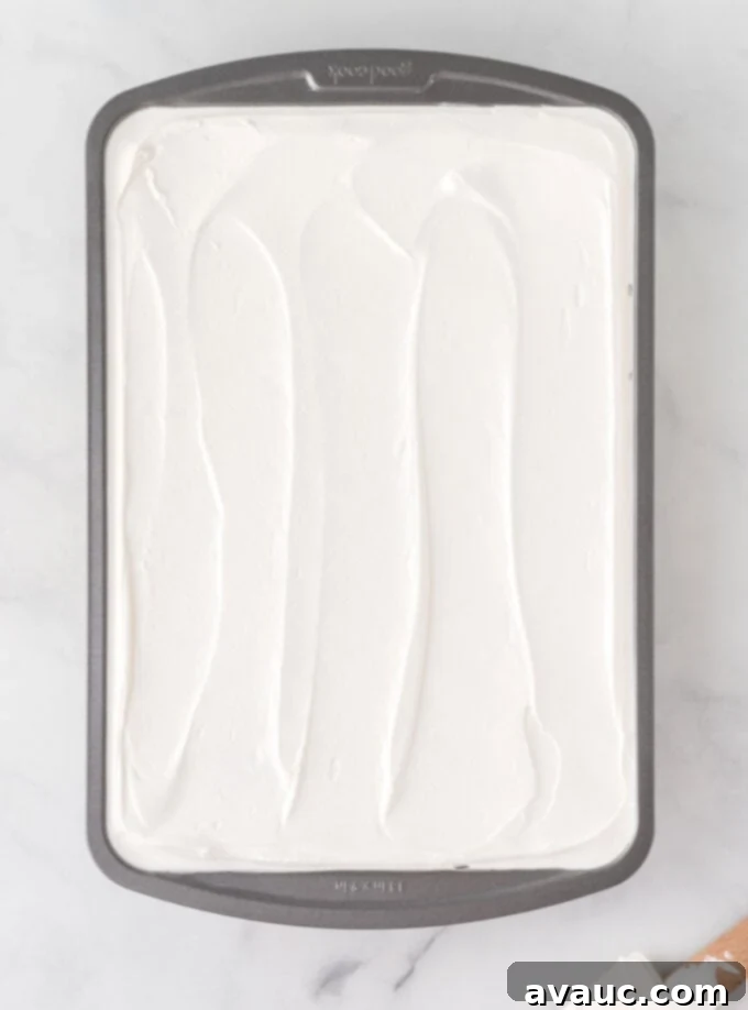Strawberry Burst Poke Cake 5 9x13 metal pan with whipped cream