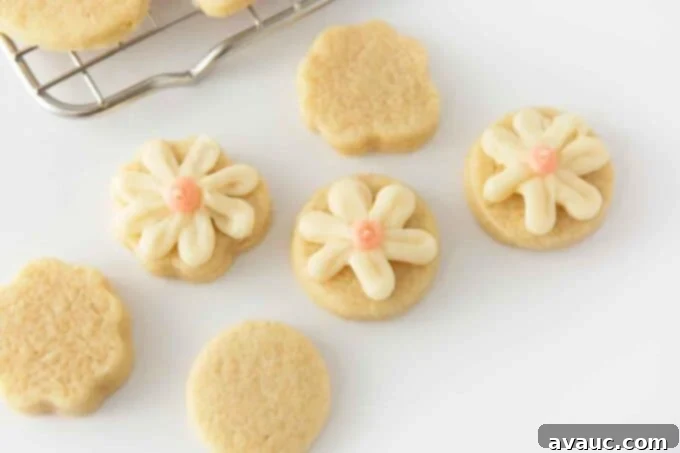 7 Delightful Easter Cookie Designs, Made Easy 7 Small circle sugar cookies decorated with white and pink frosting to look like flowers