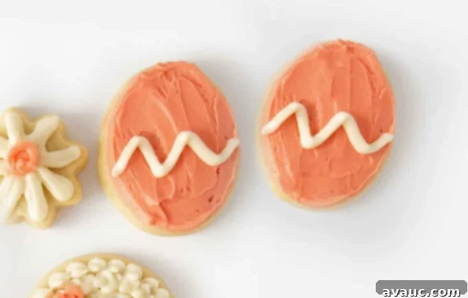 7 Delightful Easter Cookie Designs, Made Easy 8 Pink easter egg sugar cookies with white zig zag stripe in middle