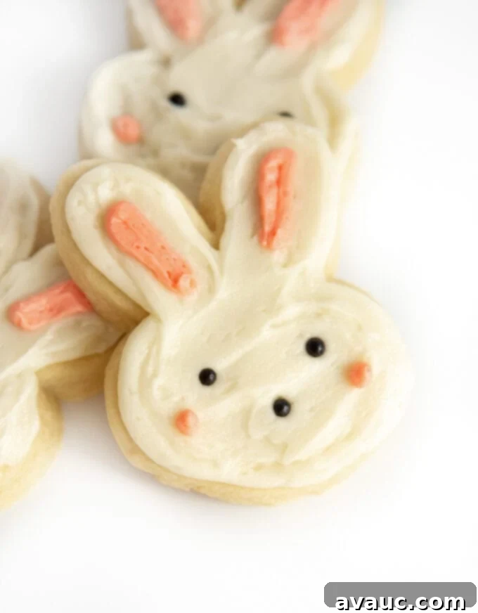 7 Delightful Easter Cookie Designs, Made Easy 9 Bunny shaped sugar cookie decorated with white and pink frosting and black pearl sprinkles for eyes