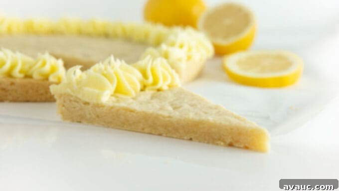 Zesty Lemon Cookie Cake 6 Close-up of a lemon cookie cake slice with a delicate lemon zest garnish.