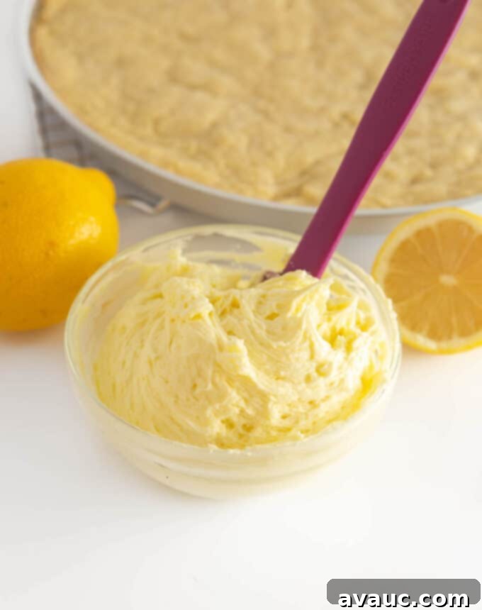 Zesty Lemon Cookie Cake 9 Lemon buttercream frosting in a bowl, ready to be spread.