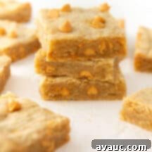 Gourmet Butterscotch Bars 10 Close-up of a perfectly baked butterscotch bar with a bite taken, showcasing its gooey center and chewy texture.