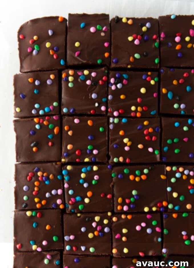 Homemade fudgy cosmic brownies with ganache and colorful sprinkles, sliced