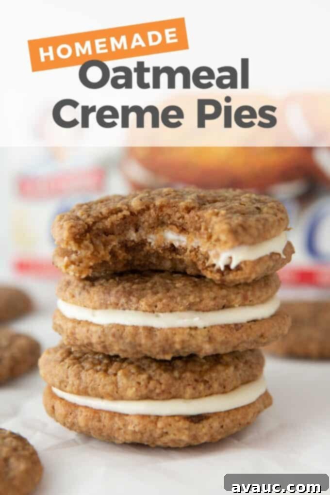 Two homemade oatmeal creme pies stacked, showing the soft cookie and fluffy white filling.