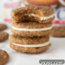 A close-up of a homemade oatmeal creme pie with its filling slightly exposed.