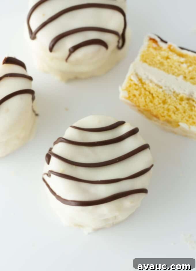 A stack of perfectly crafted homemade Zebra Cakes, showcasing the white chocolate coating and signature dark chocolate stripes, ready to be enjoyed.