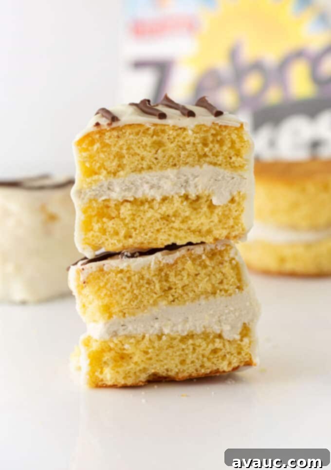 A beautifully arranged stack of finished homemade Zebra Cakes with their distinct white coating and chocolate stripes, ready for serving.