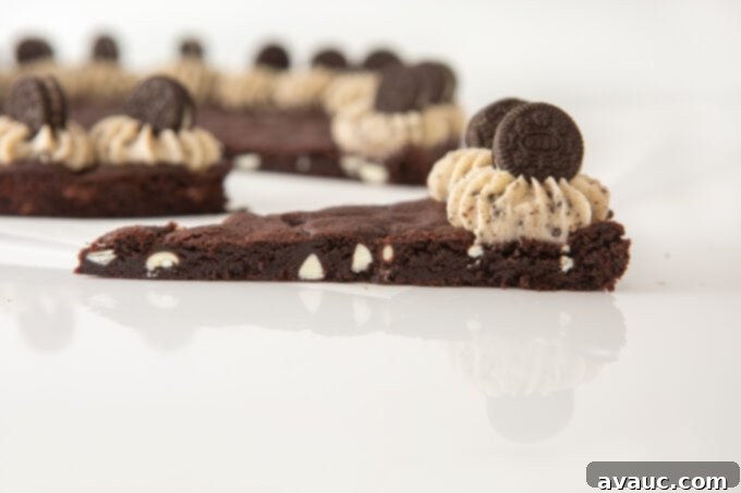 Oreo Dream Cake 9 Close-up slice of Oreo pizza cookie cake, showcasing the thick, chewy cookie and a clean cut.
