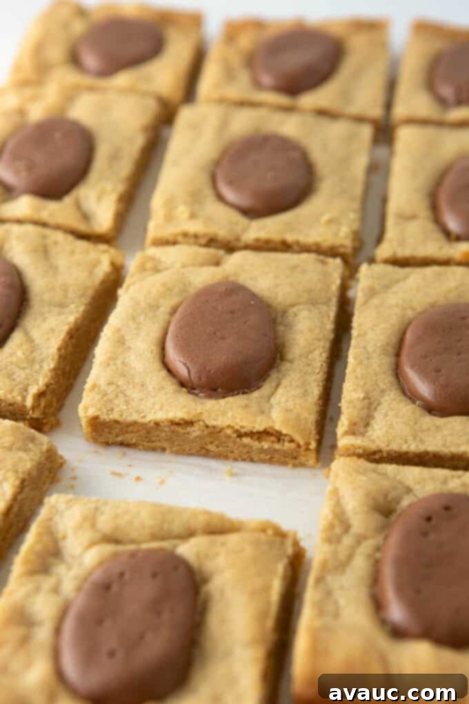 Reese's Egg Bliss Bars 2 Soft and chewy Reese's Egg Peanut Butter Bars, perfect for Easter, in a 9x13 pan with melted Reese's Eggs on top.