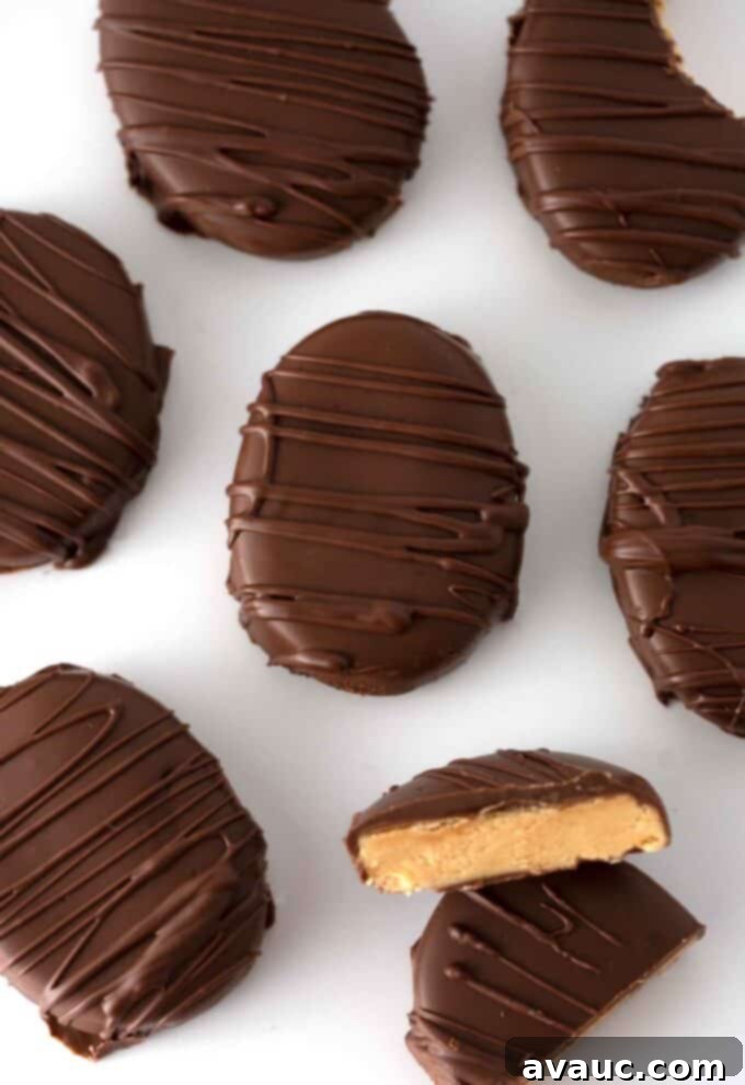 Irresistible Homemade Peanut Butter Eggs 2 Homemade peanut butter eggs dipped in chocolate with a delicate chocolate drizzle on a cooling rack