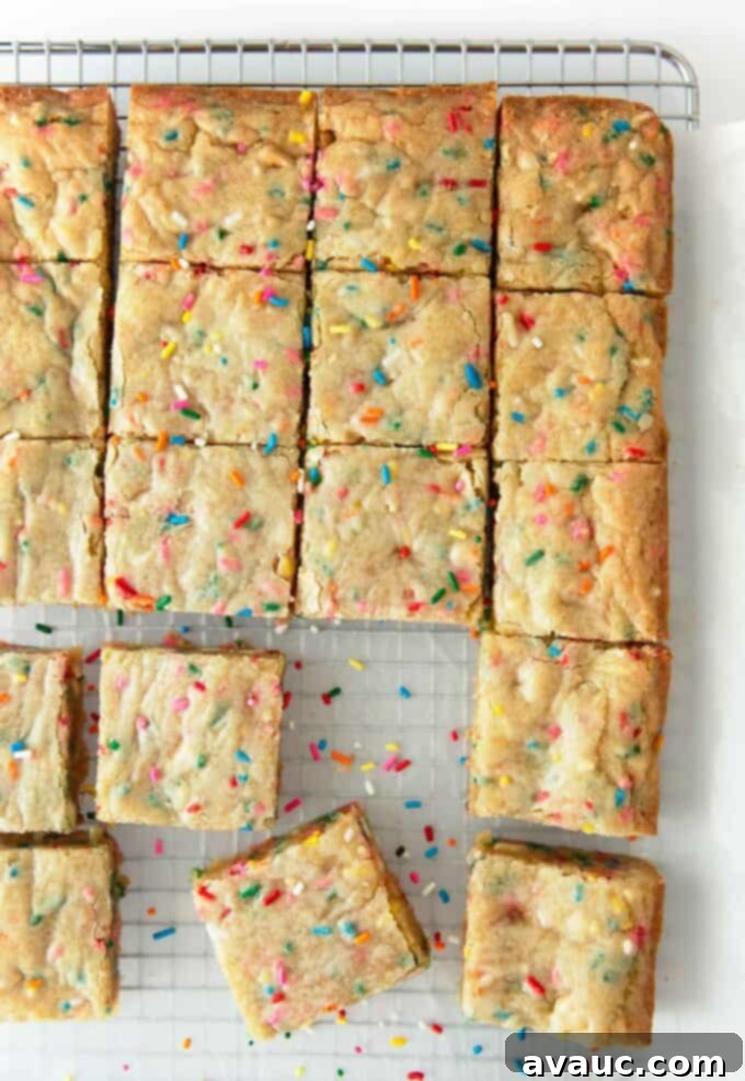 Delicious Thick and Chewy Funfetti Blondies 2 Thick and chewy funfetti blondies cut into squares on a white plate