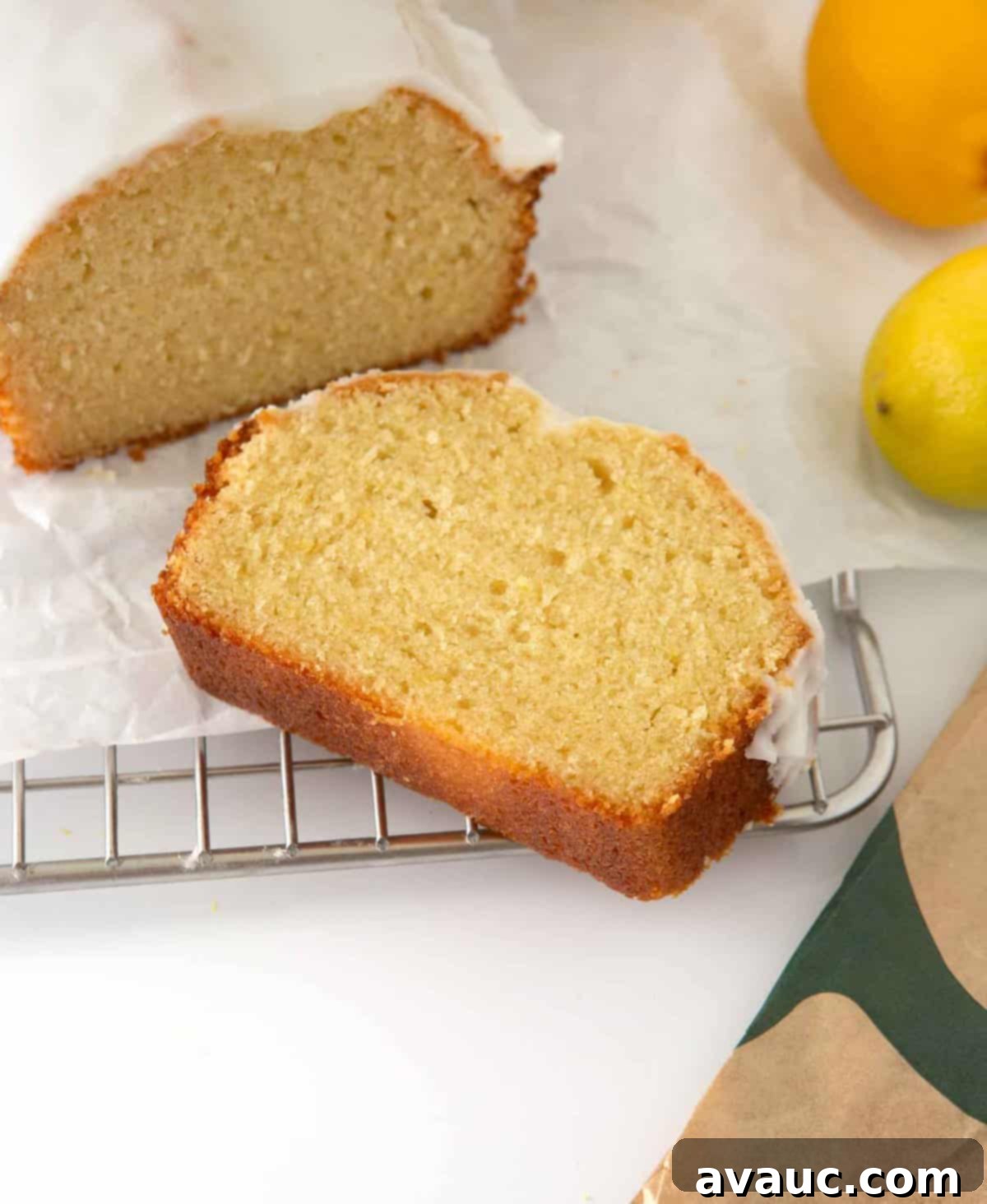 Starbucks-Inspired Lemon Loaf 2 A perfectly sliced piece of moist lemon loaf with sweet glaze, resting on a cooling rack, ready to be enjoyed.