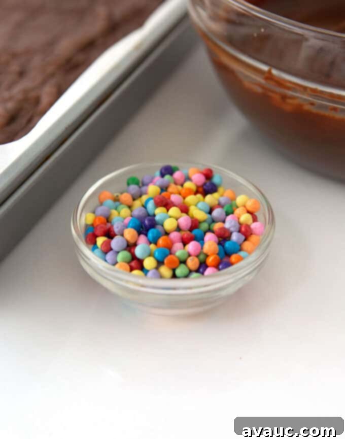 A bowl of freshly made chocolate frosting, glossy and ready to spread.