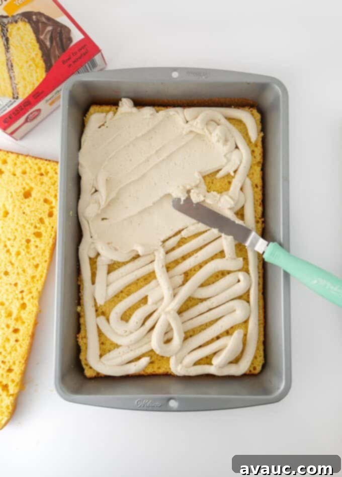 9x13 Zebra Sheet Cake 7 Overhead view of frosting being spread onto bottom half of zebra cake