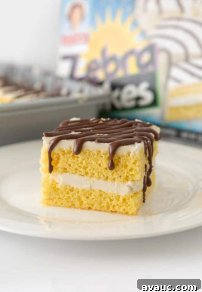 9x13 Zebra Sheet Cake 9 Square of homemade zebra cake on plate with box of Little Debbie zebra cakes in background