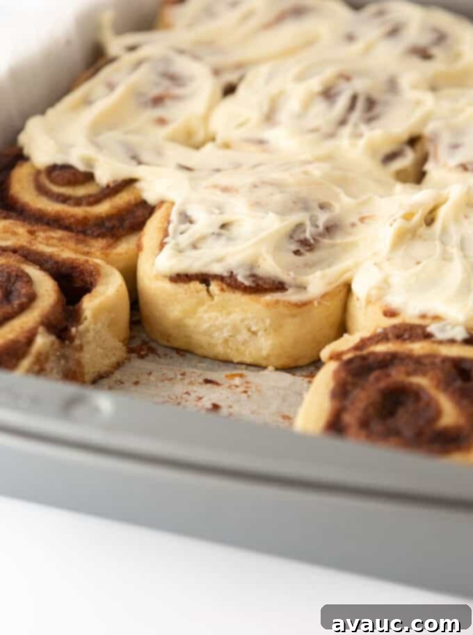 Perfectly frosted cinnamon rolls with a thick layer of cream cheese frosting.