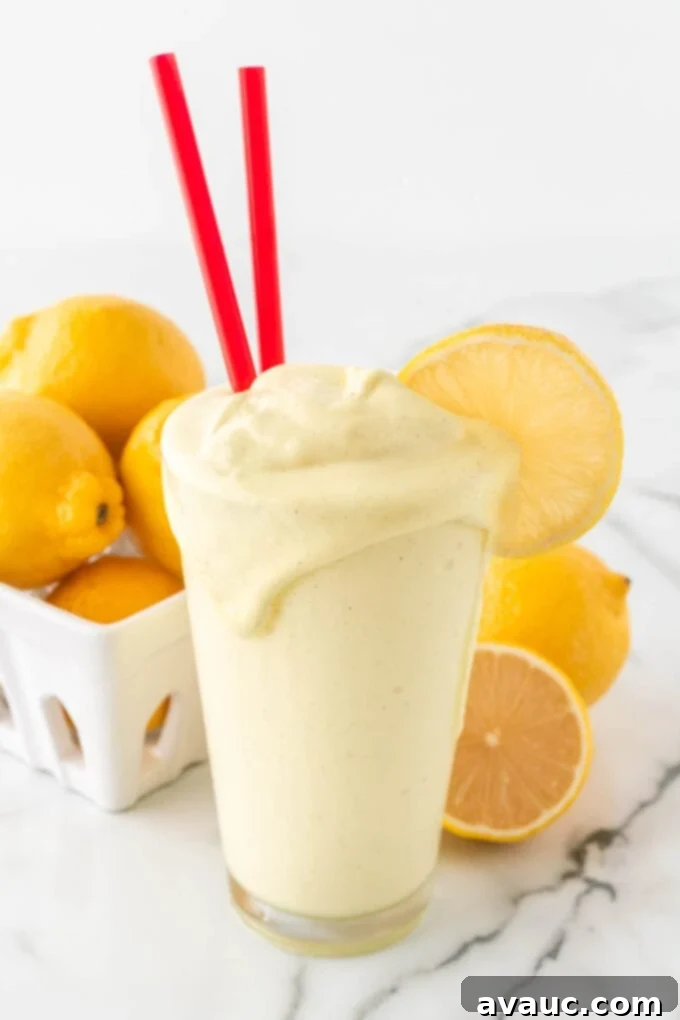 Homemade Chick-fil-A Frosted Lemonade 2 Glass of copycat Chick-fil-A frosted lemonade with red straws, ready to be enjoyed.