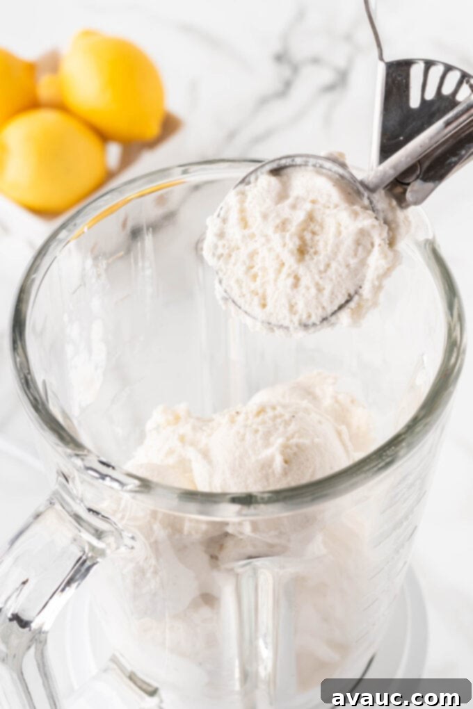 Homemade Chick-fil-A Frosted Lemonade 5 Scooping vanilla ice cream into a blender for frosted lemonade.