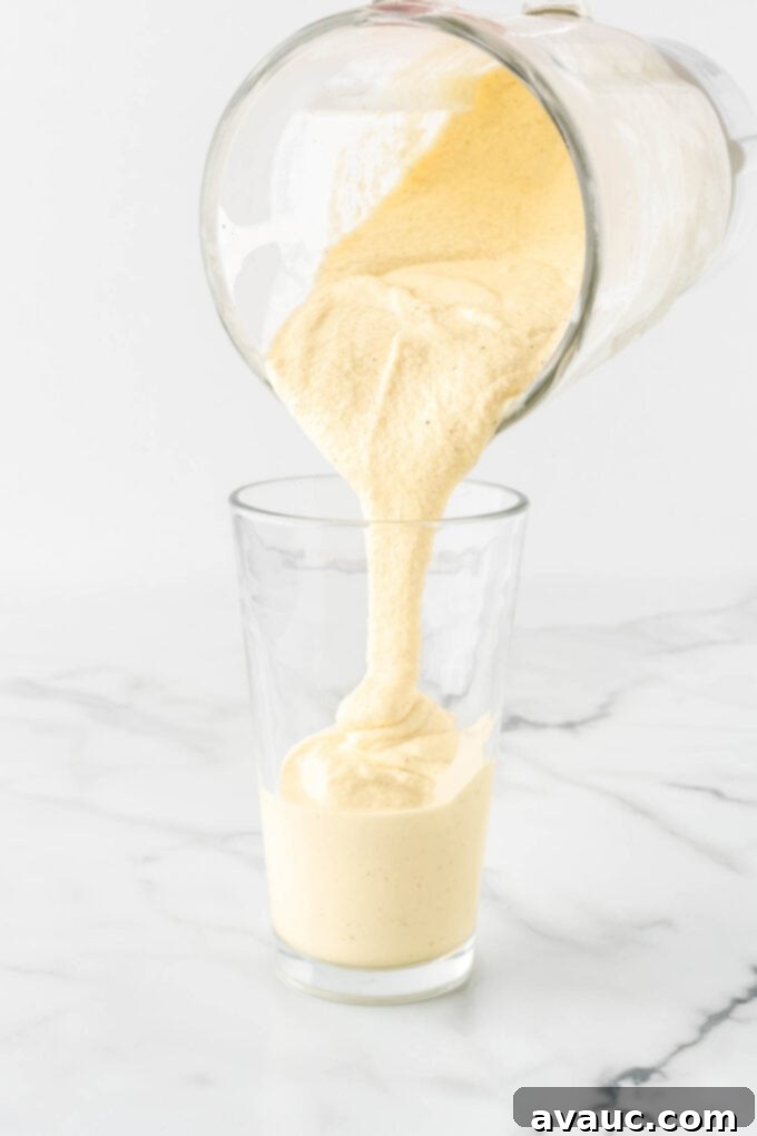 Homemade Chick-fil-A Frosted Lemonade 10 Pouring freshly blended frosted lemonade into a glass cup.