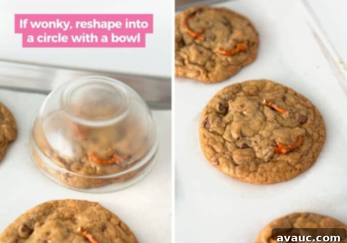 Freshly baked Kitchen Sink Cookies cooling on a baking sheet with parchment paper.