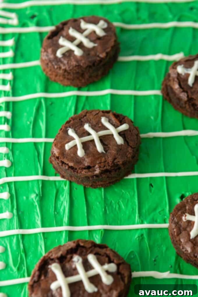 Touchdown Mini Brownies 4 mini football brownies arranged beautifully on a green-colored serving platter, resembling a football field