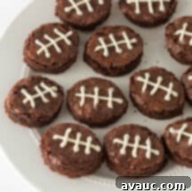 Touchdown Mini Brownies 10 delicious mini football brownies with white laces on a dark background, ready to be served