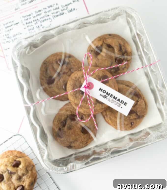A foil square pan filled with perfectly baked chocolate chip cookies, wrapped with rustic twine and a "Homemade with Love" gift tag, ready for gifting.