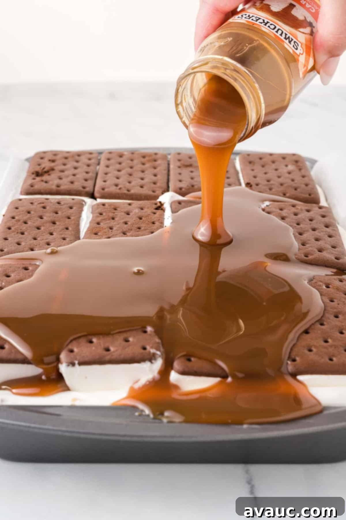 Dreamy Ice Cream Sandwich Cake 12 Pouring warm caramel sauce over the vanilla ice cream sandwich layer