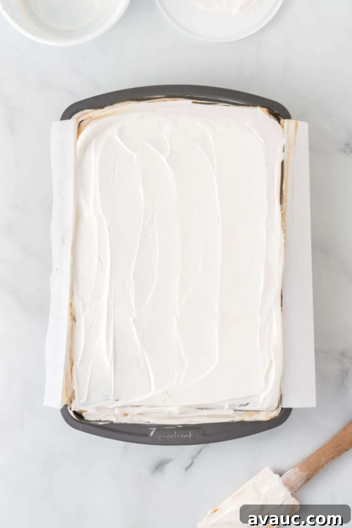 Dreamy Ice Cream Sandwich Cake 14 Overhead view of ice cream sandwich cake in pan after frosting with whipped topping and sprinkles