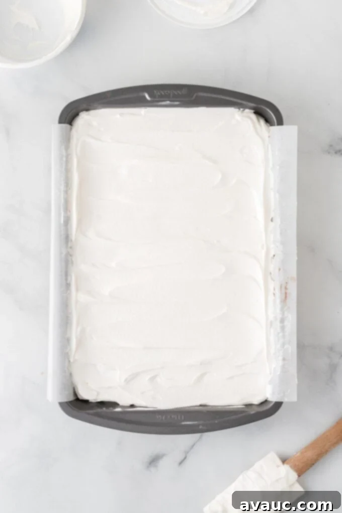 Dreamy Ice Cream Sandwich Cake 10 Overhead view of ice cream sandwich cake after adding a smooth layer of whipped topping