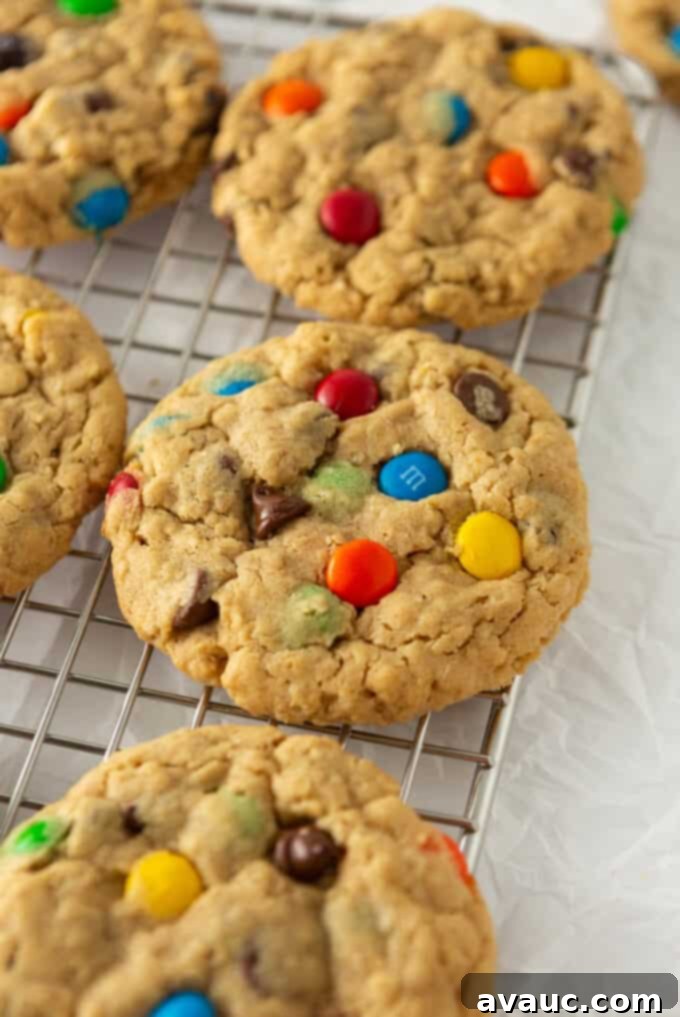 Close up of a freshly baked M&M Monster Cookie, showing its soft and thick texture, ready to be eaten