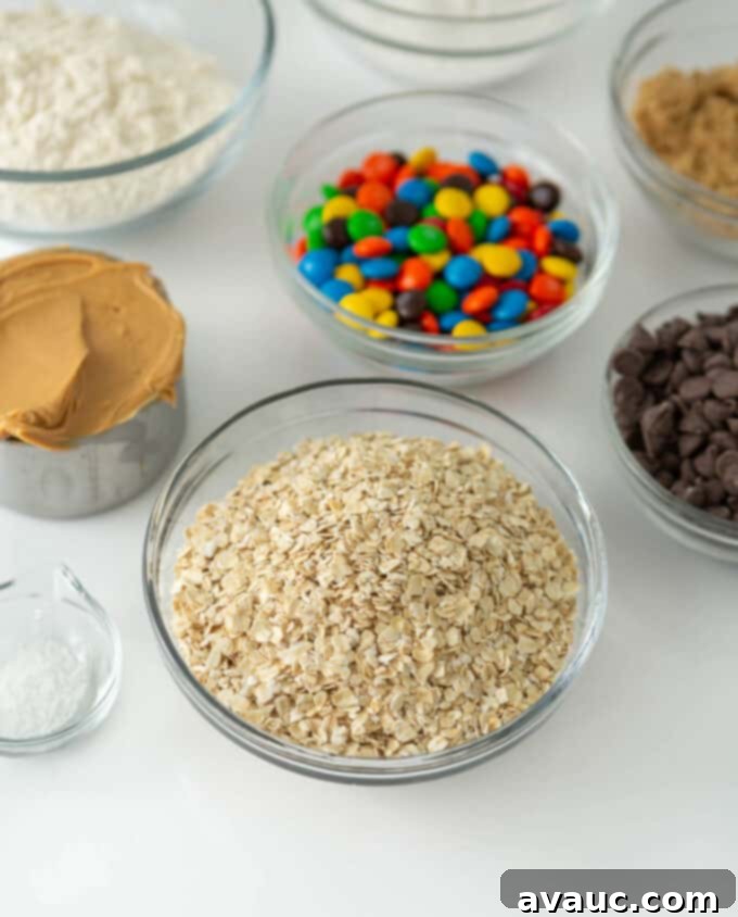 All the essential ingredients for monster cookies laid out on a kitchen counter, ready for baking