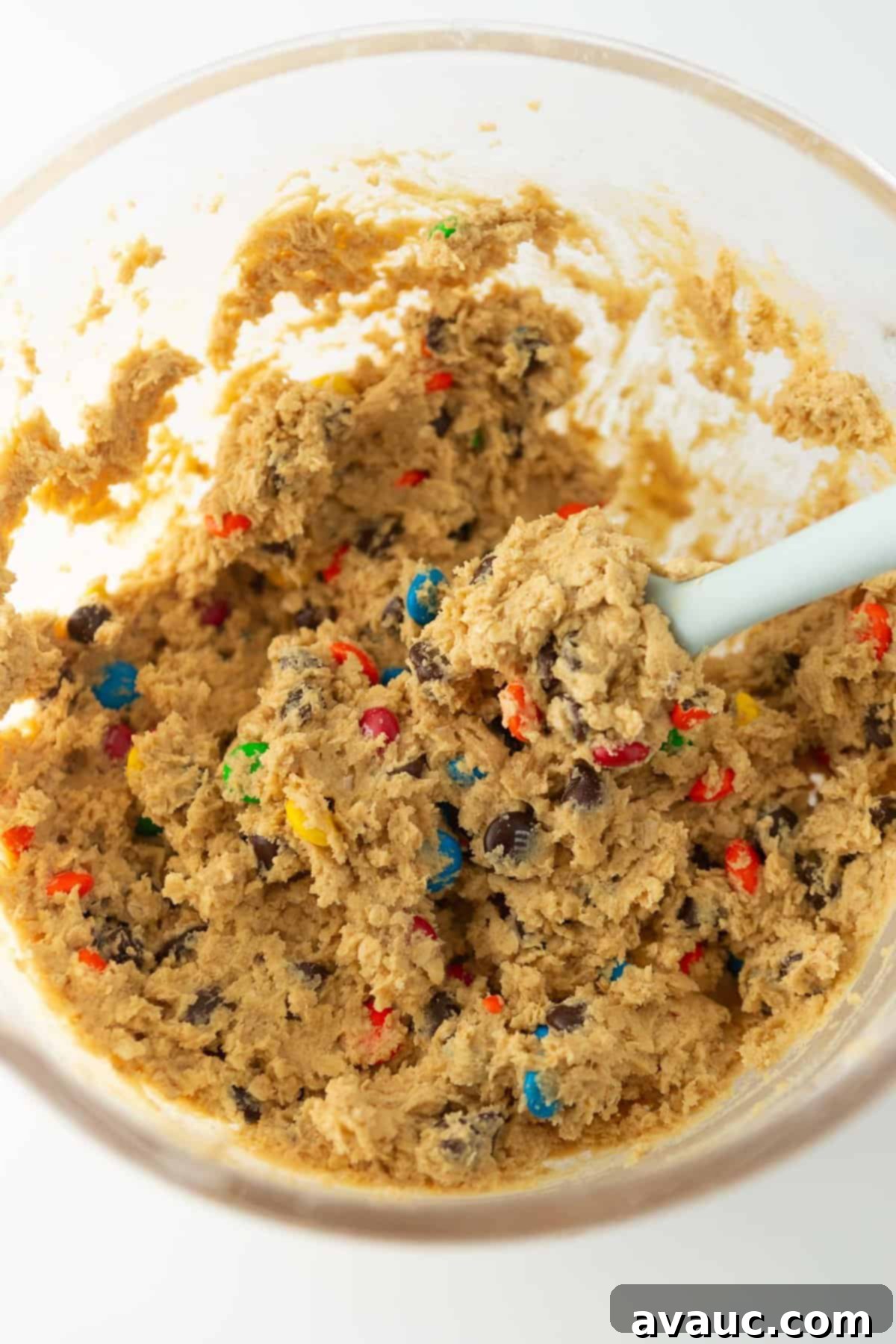 Close up of monster cookie dough, showing its rich texture and plentiful mix-ins