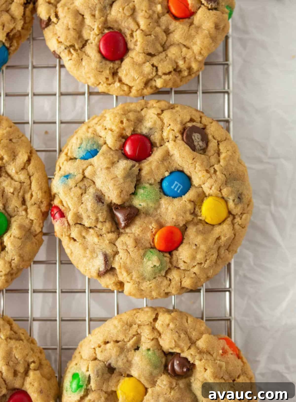 Monster cookies cooling on a wire rack, preserving their soft and chewy texture as they firm up