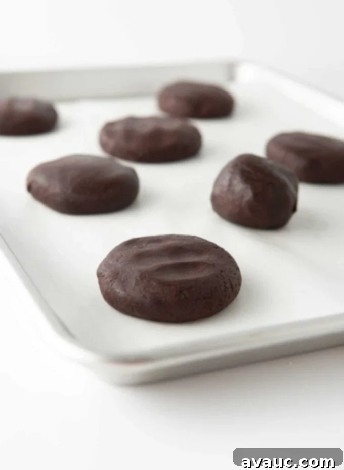 Fudgy Cosmic Brownie Cookies 7 flattened cookie dough ball on pan