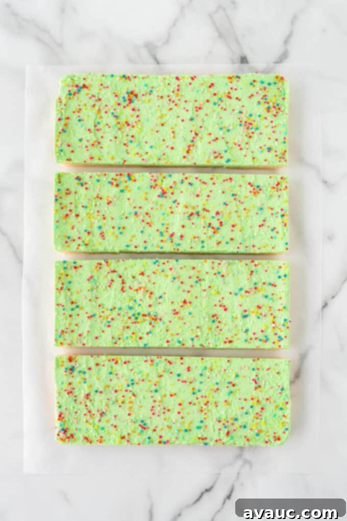 Festive Christmas Tree Sugar Cookie Bars 11 Step 2 of how to cut triangle Christmas trees out of a 9x13 pan of sugar cookie bars: cut into 4 quadrants.