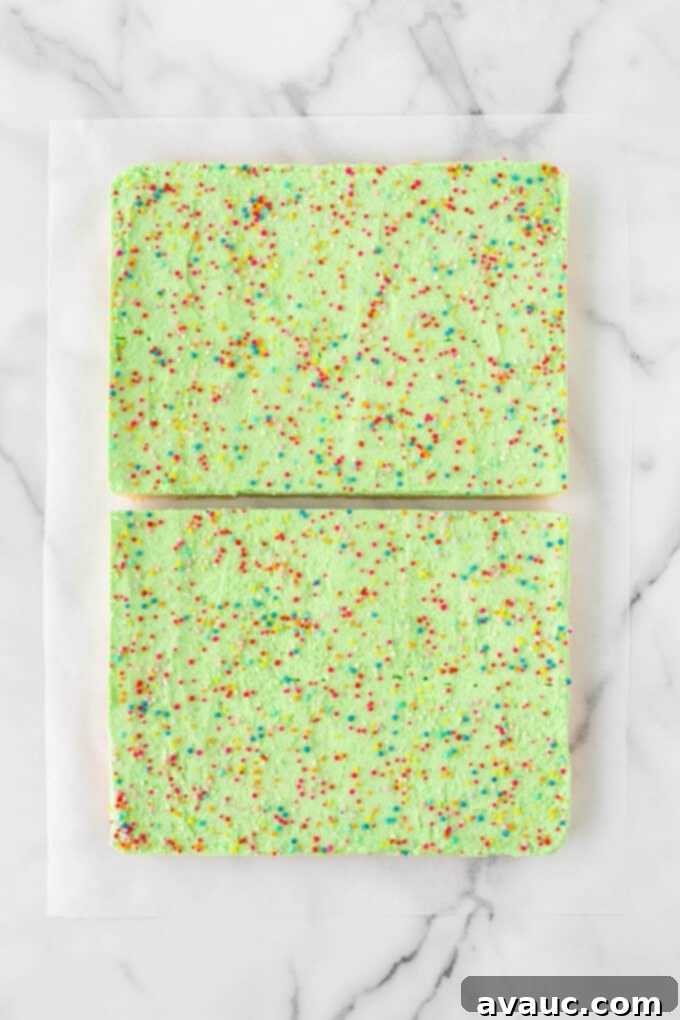Festive Christmas Tree Sugar Cookie Bars 10 Step 1 of how to cut triangle Christmas trees out of a 9x13 pan of sugar cookie bars: cut the bars in half horizontally.