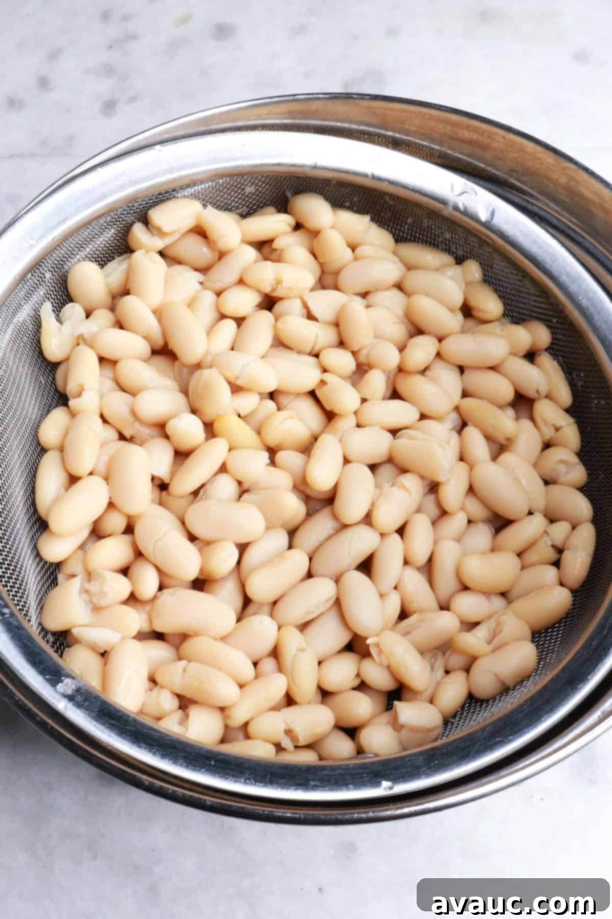 Foolproof White Chicken Chili with Hominy 4 White beans in a colander over a bowl