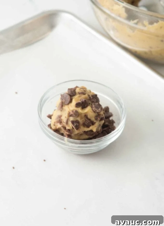 rolling dough ball in bowl of chopped chocolate