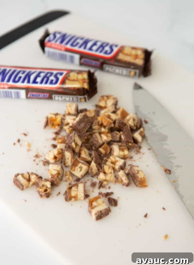 Decadent Chewy Snickers Cookies 5 Chopped Snickers bars in small pieces ready to be added to cookie dough