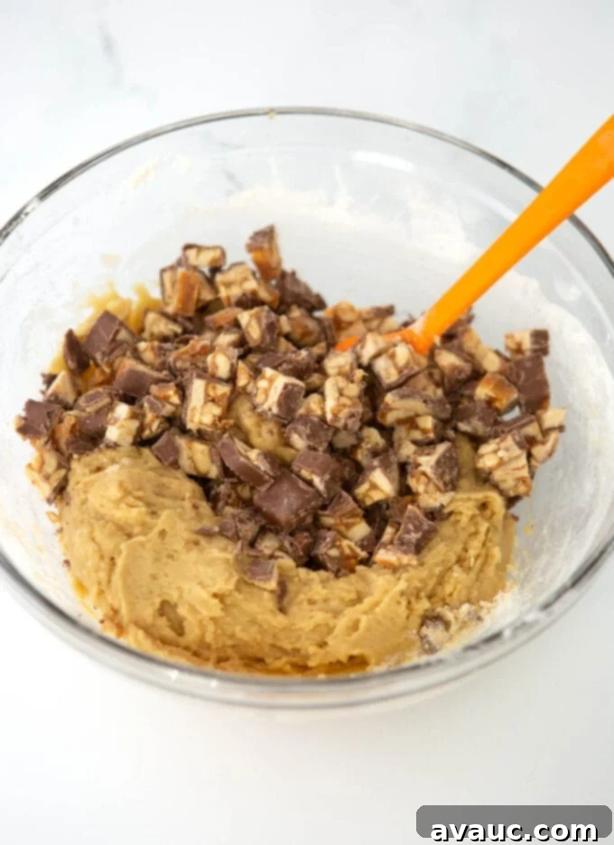 Decadent Chewy Snickers Cookies 6 Bowl of freshly mixed Snickers cookie dough with candy bar pieces