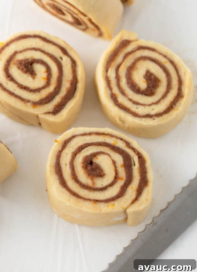 One-Hour Citrus Cinnamon Buns 14 Sliced orange cinnamon roll dough arranged in a pan