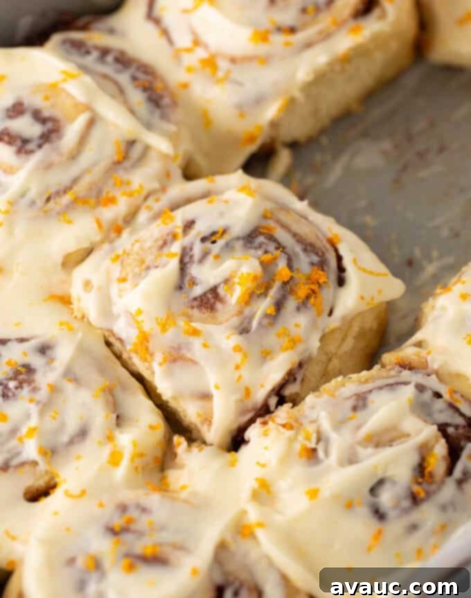 One-Hour Citrus Cinnamon Buns 18 Gooey orange cinnamon rolls with cream cheese frosting, close-up