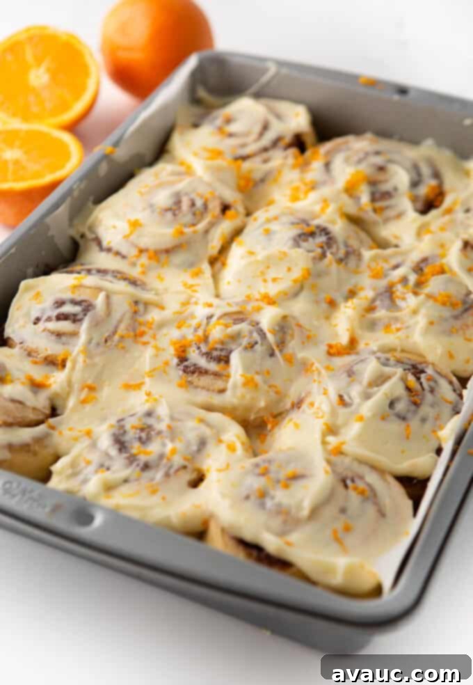 One-Hour Citrus Cinnamon Buns 3 9x13 pan of orange cinnamon rolls topped with cream cheese frosting and orange zest
