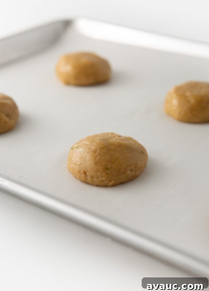 key lime cookie dough balls slightly flattened on baking tray