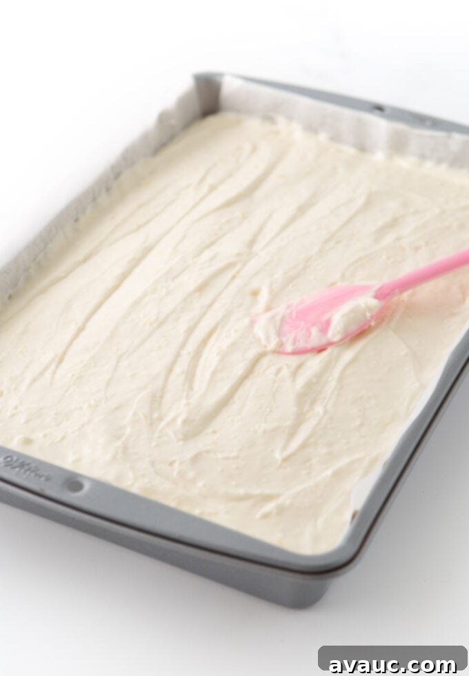 Easy No Bake Lemon Cheesecake Squares 11 no bake lemon cheesecake filling spread in 9x13 pan