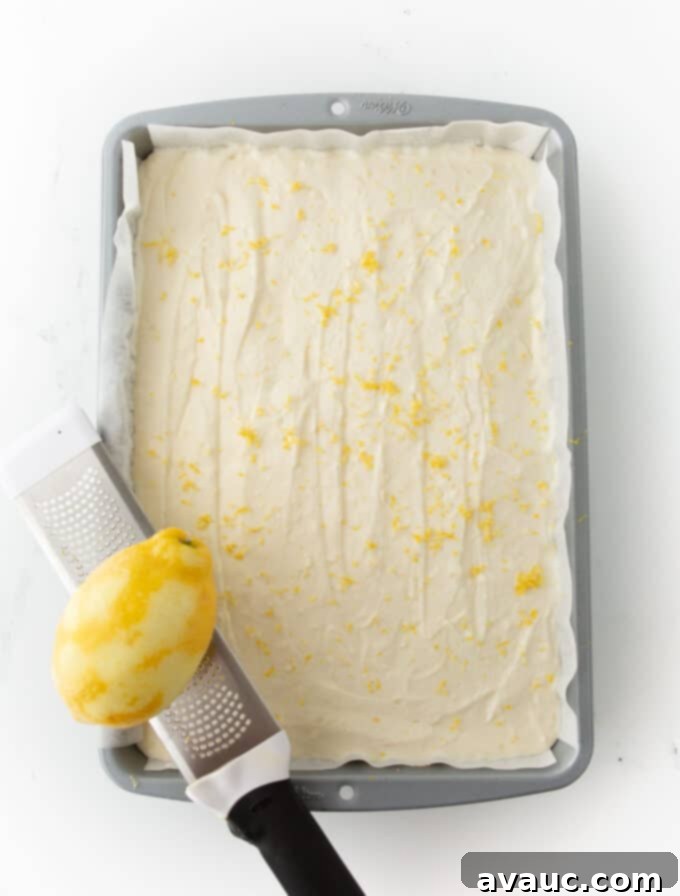 Easy No Bake Lemon Cheesecake Squares 12 pan of no bake lemon cheesecake bars with zest on top